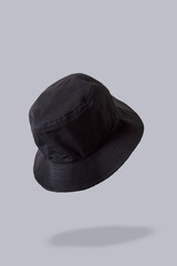 black bucket hat, grey background 