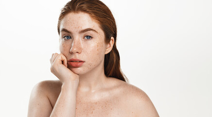 Portrait of young redhead woman plus size, chubby model with glowing clear skin, healthy face and...