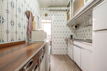 vintage kitchen decorated with old kitsch tiles and formica cabinets