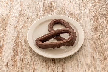 snack of fried churros covered in a layer of milk chocolate