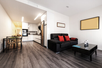 Connected living room with dining table and kitchen in vacation rental studio