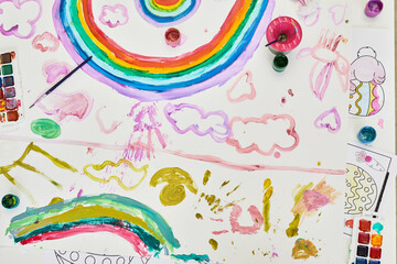 Top view background image of childrens drawing with rainbow at art and craft class on Easter, copy space