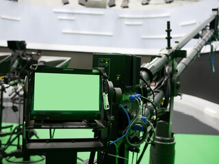 camera monitor of professional studio camera with virtual green screen at TV station.