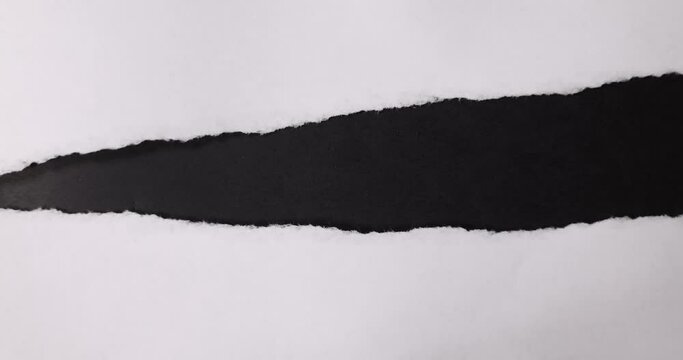 A small strip in the middle of the sheet breaks off from the white paper.