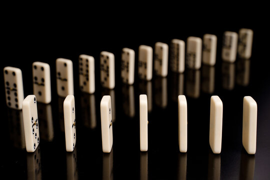 Close-up of domino game on a black background.
