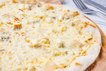Pizza Quattro formaggi on white wooden table