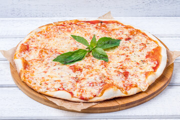 Italian pizza Margherita on white wooden table