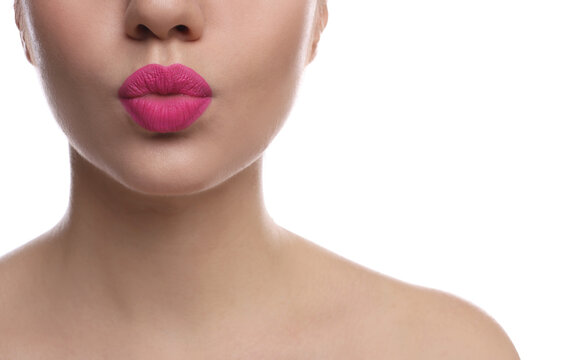 Closeup view of beautiful woman puckering lips for kiss on white background