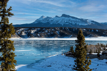 beautiful frozen blue water in Nordegg Alberta winter with mountains 