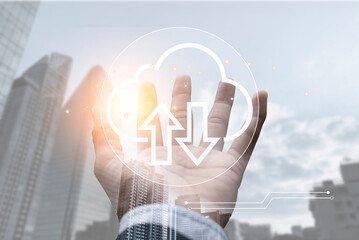 Double exposure of businessman hand holding cloud technology icon over cityscape with sunrise. Demonstrates fast online data transfer technology.