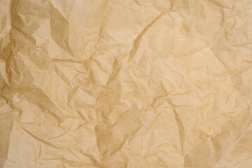 Texture of crumpled brown baking paper as background, closeup