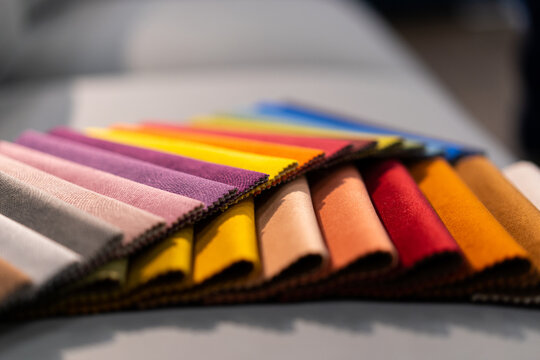 Tissue catalog. Catalog of multi-colored fabric samples. Textile industry background. Colored cotton fabric. Tissue catalog. Selects the color of the sofa. Textile industry background. Palet