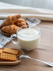 Th cup of yogurt and bread biscuits on the table