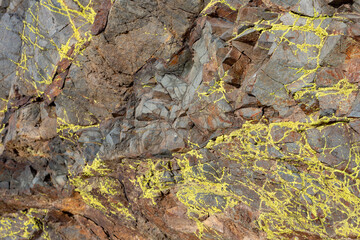 Obraz premium Red and yellow rocks with green moss