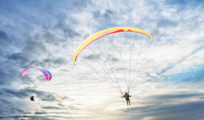 Paragliding in the sky. Paraglider  flying over Landscape from Beautiful View Mekong River at Wat Pha Tak Suea in Nongkhai, Thailand.Aerial view. Concept of extreme sport, taking adventure/ challenge.