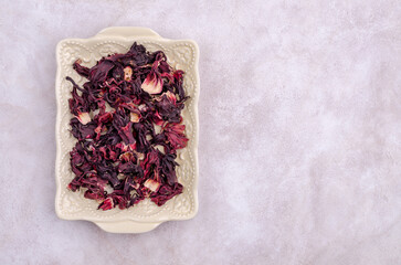 Dried hibiscus petals in a ceramic bowl
