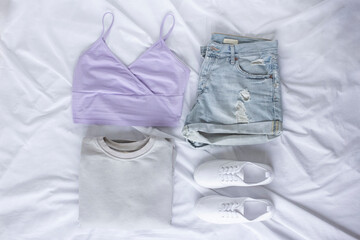 Female trendy clothes flat lay on white sheet background, look of the day