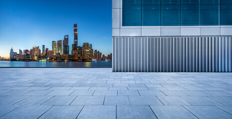 Fototapeta na wymiar Empty square floor and city skyline with buildings in Shanghai at night, China.