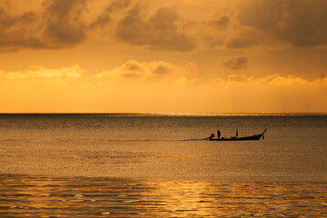 Long-tail boat ride on the sunset over the sea