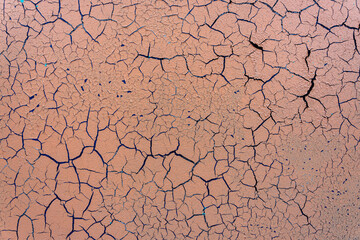 Cracked and damaged painted surface of a building or wall. Texture, aged paint background