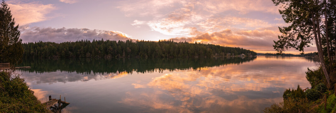 Panoramic landscape sunrise reflections on Filucy Bay, Puget Sound, Washington State Pacific Northwest