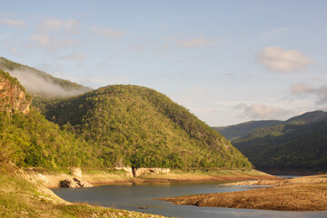 The scenery of mountains and dry water in the morning light. Dry water in the dam from the north of Thailand.