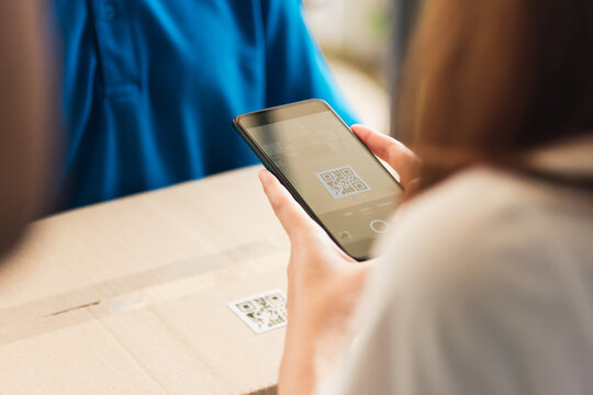 Asian Customer Young Woman Using Mobile Smartphone With QR Code Payment To Receive Parcel Post Box From Delivery Man, Hands Of Female Scanning At Door Front House, Online Shopping Service Concepts