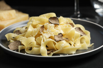 Tasty tagliatelle with truffle on table, closeup