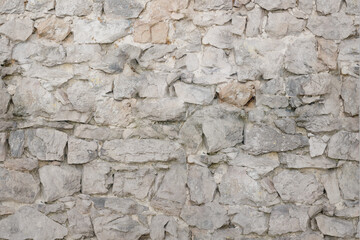 Old natural white stone wall background.