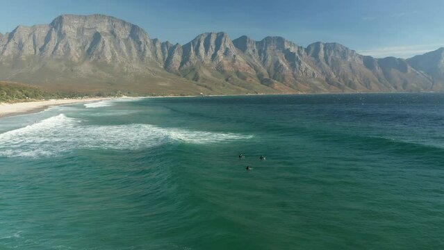 Tourists Surfing In The Beautiful Beach Of Kogel Bay Beach In Cape Town, South Africa - aerial shot