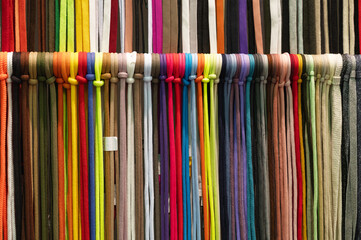 Laces samples hang on rack in light hallway at exhibition