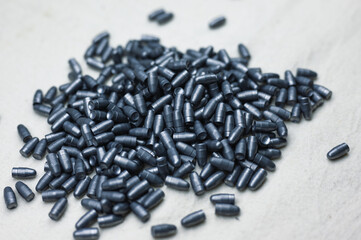 Small caliber hunter bullets lie on light fabric sheet