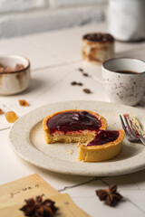 Mini tart with whipped cream cherry and lemon sweet dessert on white plate