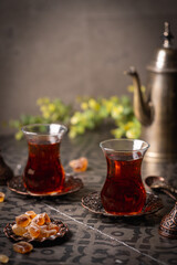 Turkish tea in traditional glass closeup on tile background