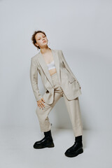 portrait of a young woman classic suit fashion posing fun light background unaltered