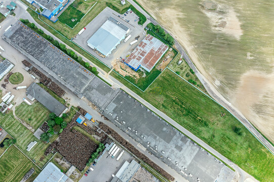 group of large industrial warehouses or factory buildings in suburban city area. drone photo.