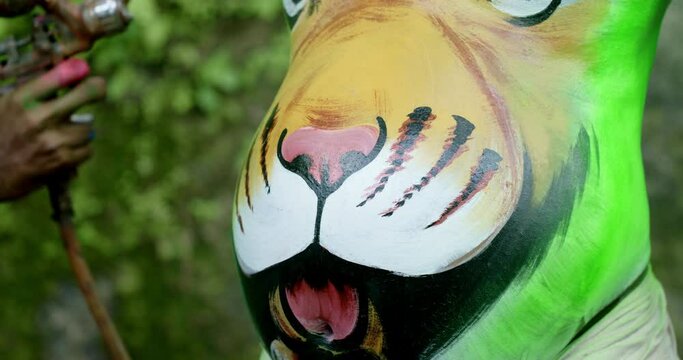 A sprayer used for spraying green paint on a dance performer's belly with the body art of a tiger for the Pulikali  Festival, also called the Tiger dance festival in Kerala, India.
