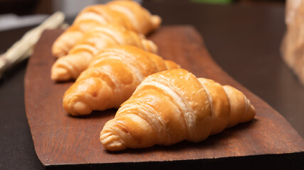 Fresh croissants on a wooden board. Fresh bakery croissants.selective focus.
