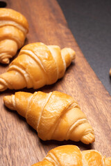 Fresh croissants on a wooden board. Fresh bakery croissants.selective focus.