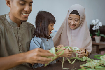 muslim asian family making ketupat for eid mubarak together