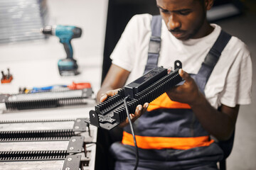 Factory worker with product at his desk
