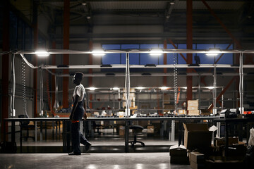 African factory worker delivering box at the storage