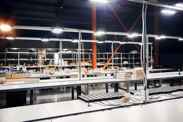 LED factory interior with lamps, working desks and equipment