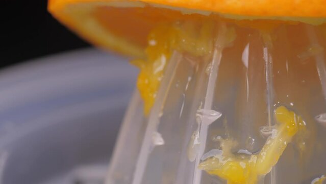 squeezing orange using squeezer slow motion 4k