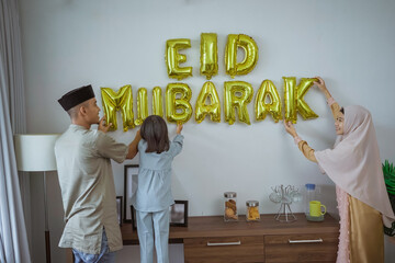 muslim decorating eid mubarak letter made of baloon