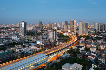 Naklejka na ściany i meble Aerial view of highway street road at Bangkok Downtown Skyline, Thailand. Financial district and business centers in smart urban city in Asia. Skyscraper and high-rise buildings at night.