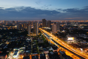 Naklejka na ściany i meble Aerial view of highway street road at Bangkok Downtown Skyline, Thailand. Financial district and business centers in smart urban city in Asia. Skyscraper and high-rise buildings at night.