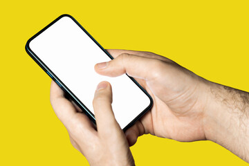 Hand holding a phone with empty white screen on yellow background