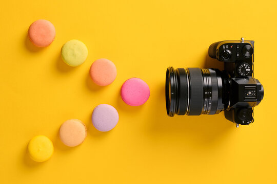 Light spectrum, color theory and photography. Colorful macarons designed as light waves with a camera.