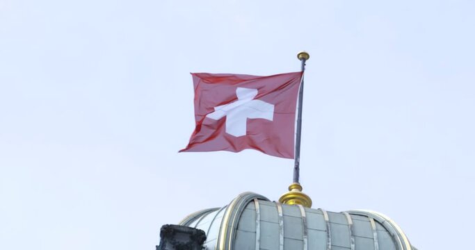Swiss flag at the top of Federal Palace of Switzerland in Bern